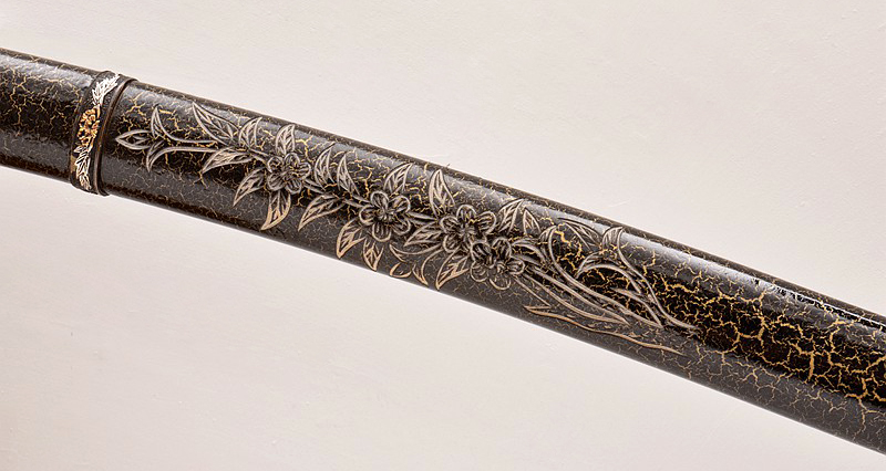 Close up view of hand carved engraving on Japanese sword saya Close up view of hand carved engraving on Japanese sword saya